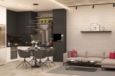 De moderne open keuken en woonkamer in dit appartement in Alanya zijn voorzien van strakke zwarte kasten, een bakstenen muur en stijlvolle verlichting.