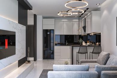 Alanyan asunto: Moderni avoin oleskelutila, jossa on tyylikäs keittiö, marmorikorosteet ja tyylikäs rengasvalaistus luovat valoisan ja kutsuvan ilmapiirin.
