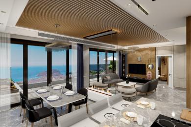 Bright, open-plan Alanya living area features a dining table, modern fireplace, and stunning ocean views.